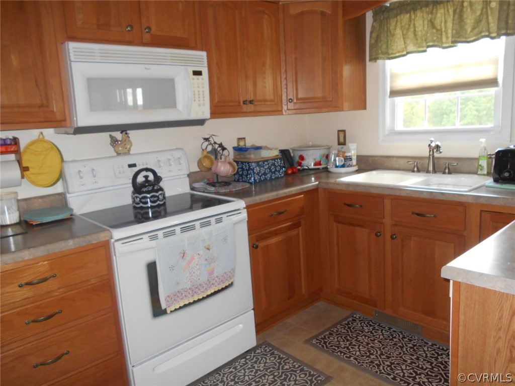 1231 Snapps Mill Road Spout Spring, VA 24593 - Photo 7 of 28 a kitchen with a sink stove and cabinets