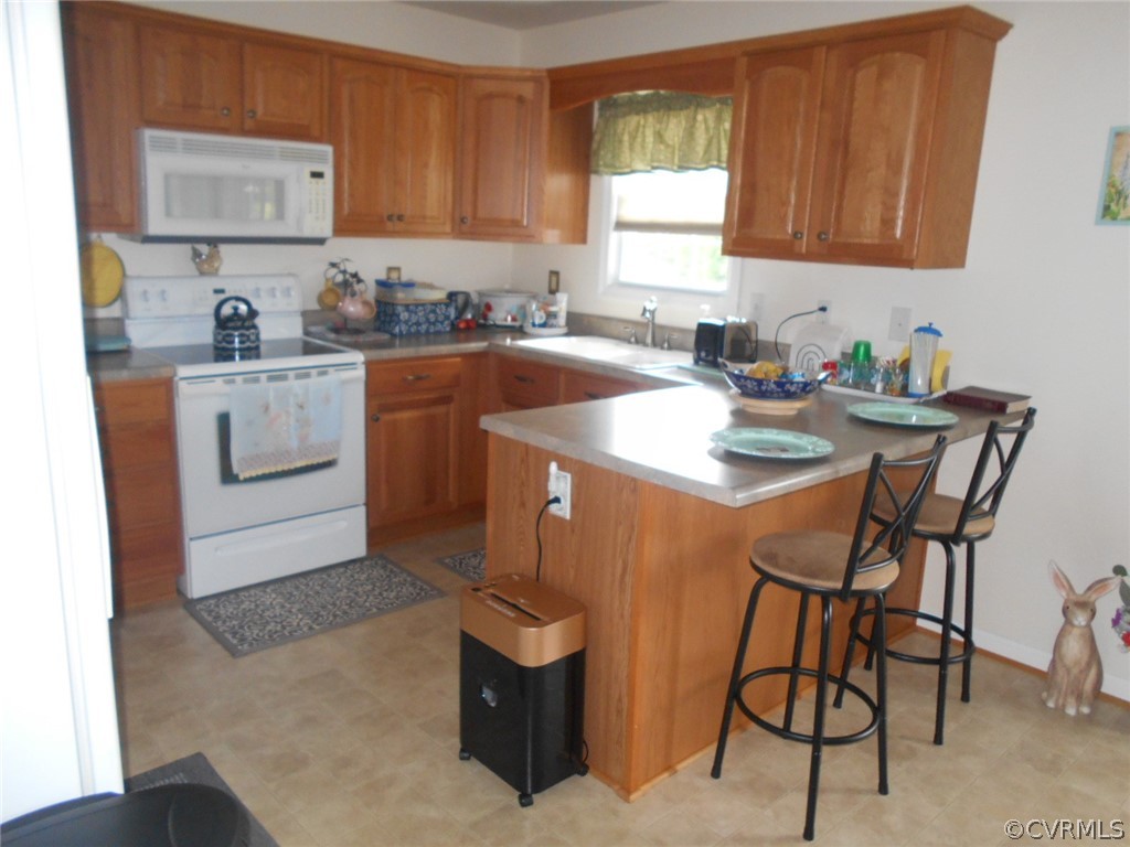 1231 Snapps Mill Road Spout Spring, VA 24593 - Photo 8 of 28 a kitchen with a sink stove and white cabinets