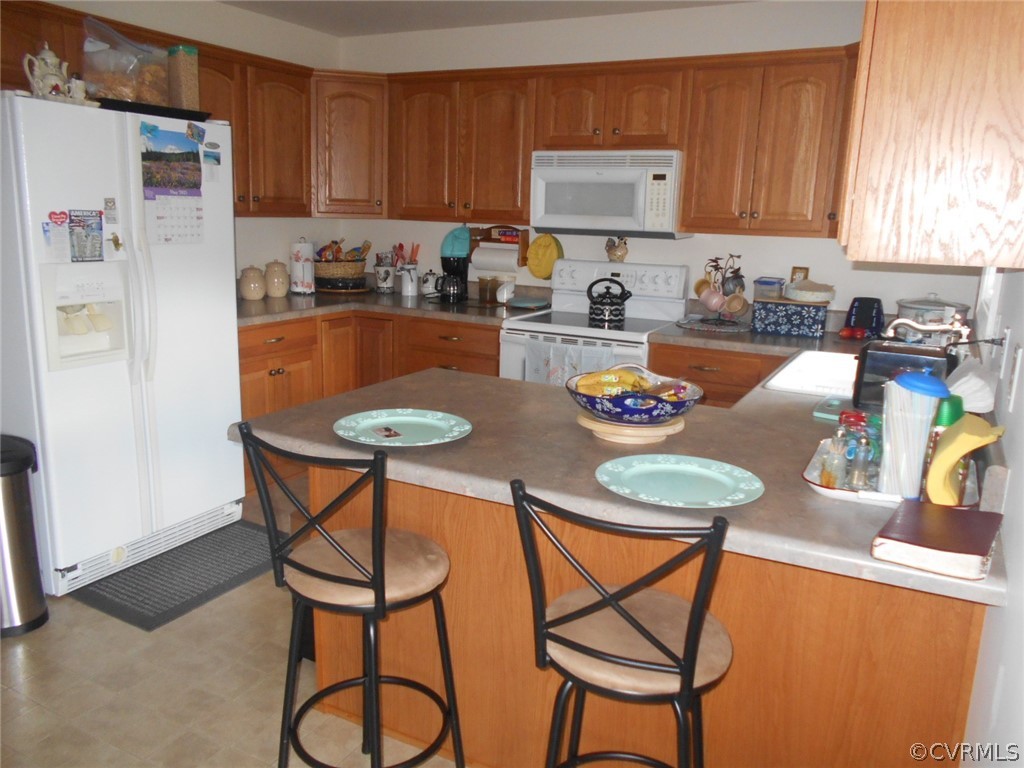 1231 Snapps Mill Road Spout Spring, VA 24593 - Photo 9 of 28 a kitchen with stainless steel appliances granite countertop a table chairs and a refrigerator