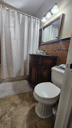 a bathroom with a toilet a sink and a shower