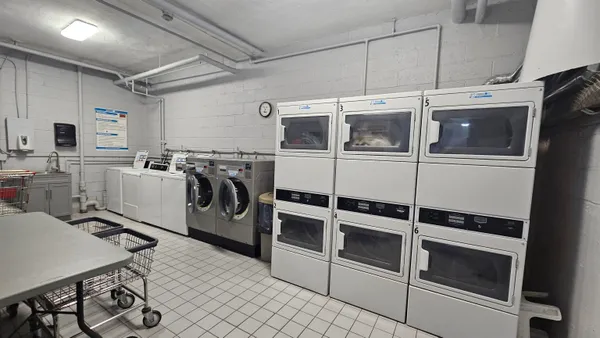 a utility room with multiple dryer and washer