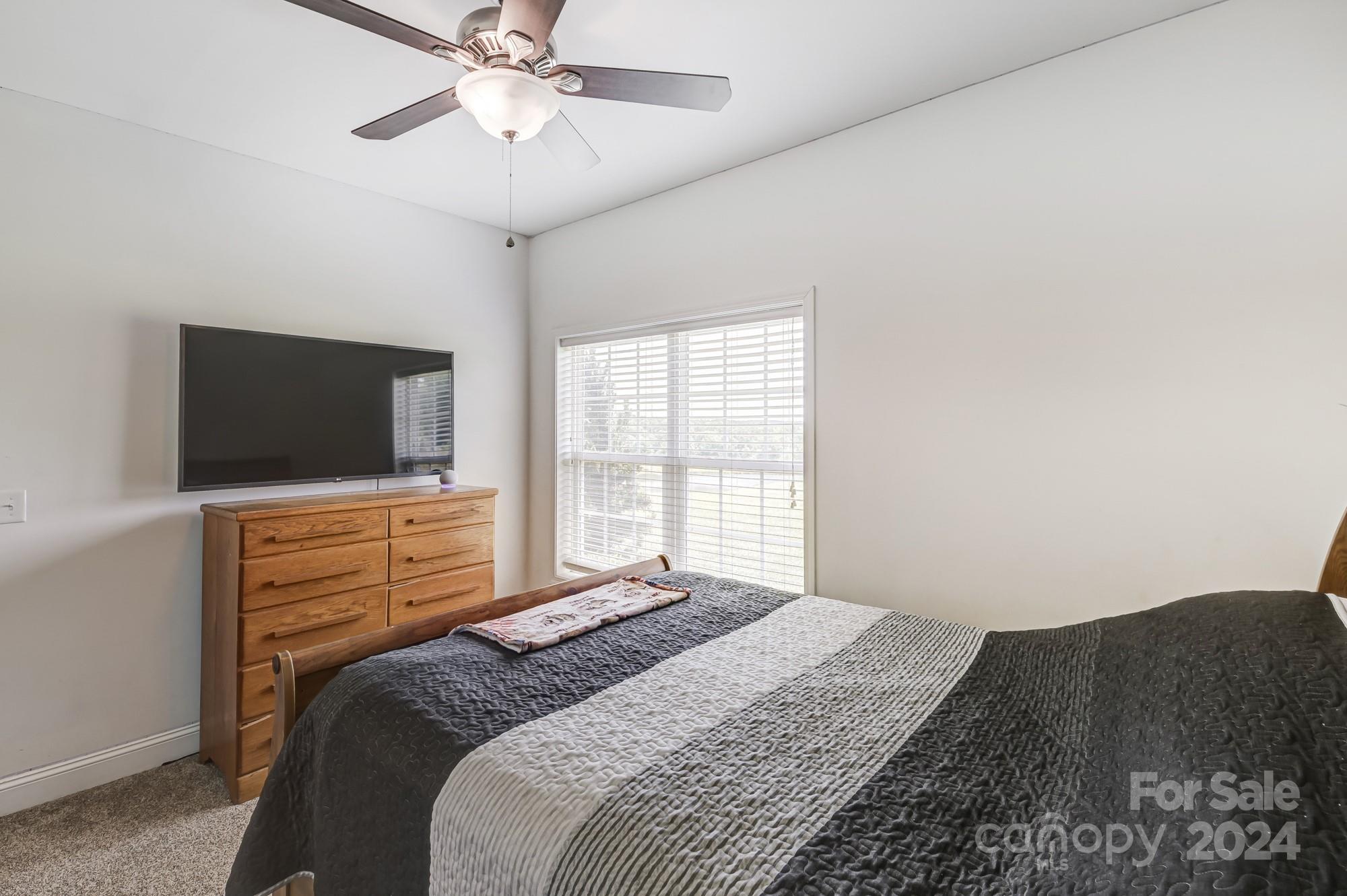 4640 Emanuel Road Gold Hill, NC 28071 - Photo 30 of 48 a bedroom with a bed and a flat screen tv