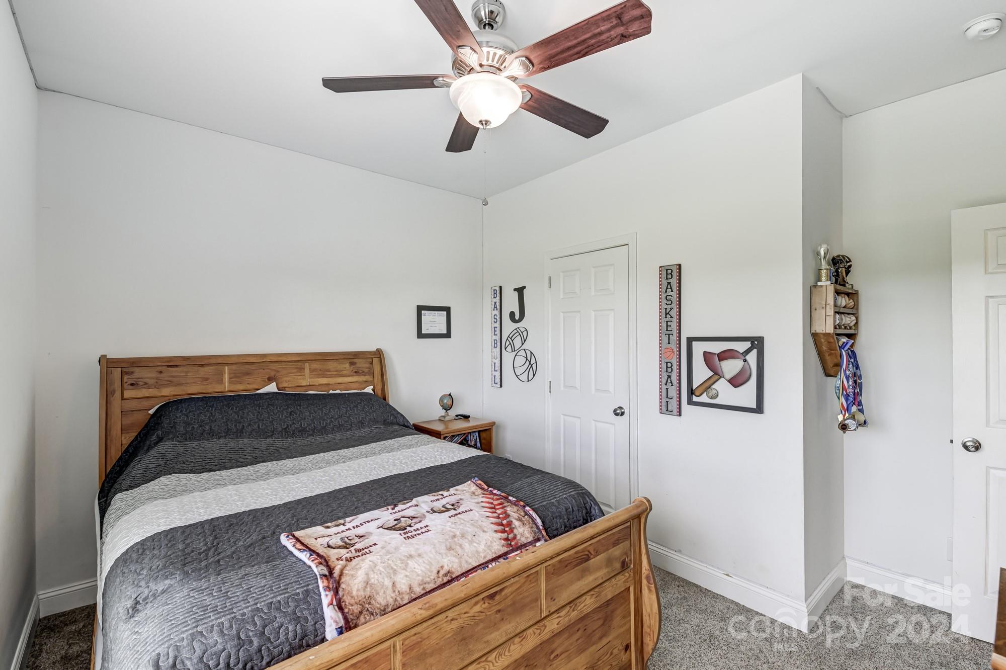 4640 Emanuel Road Gold Hill, NC 28071 - Photo 31 of 48 a bedroom with a bed and a ceiling fan
