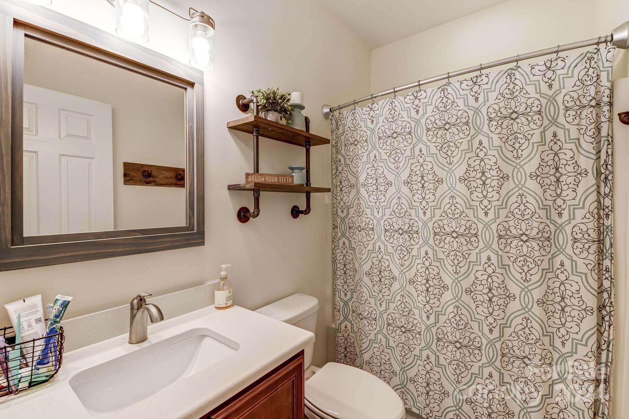 4640 Emanuel Road Gold Hill, NC 28071 - Photo 32 of 48 a bathroom with a sink toilet and mirror