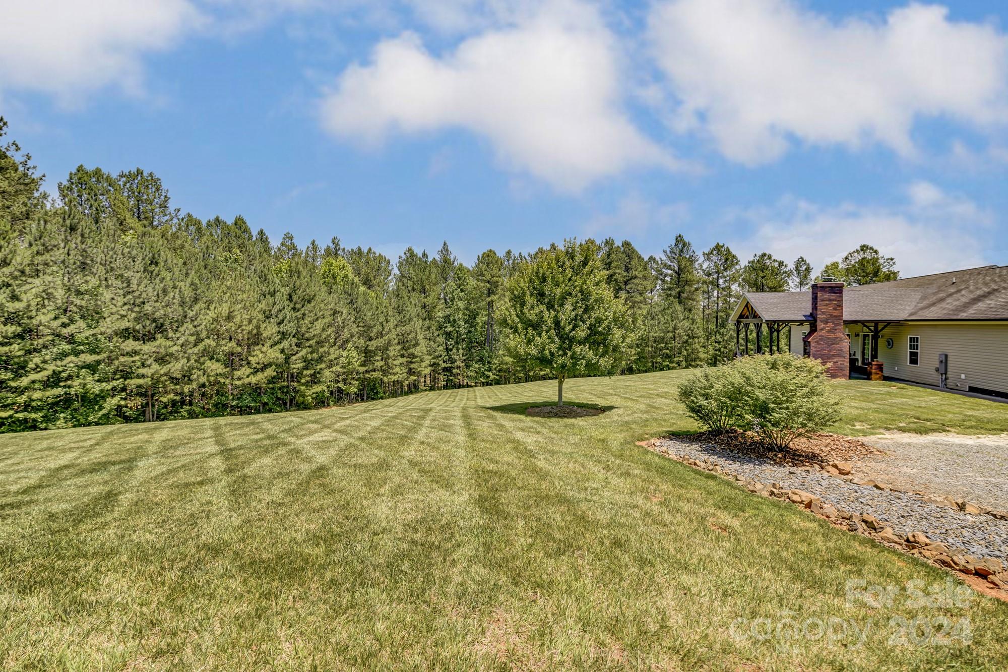 4640 Emanuel Road Gold Hill, NC 28071 - Photo 46 of 48 a view of a yard with an house and wooden fence