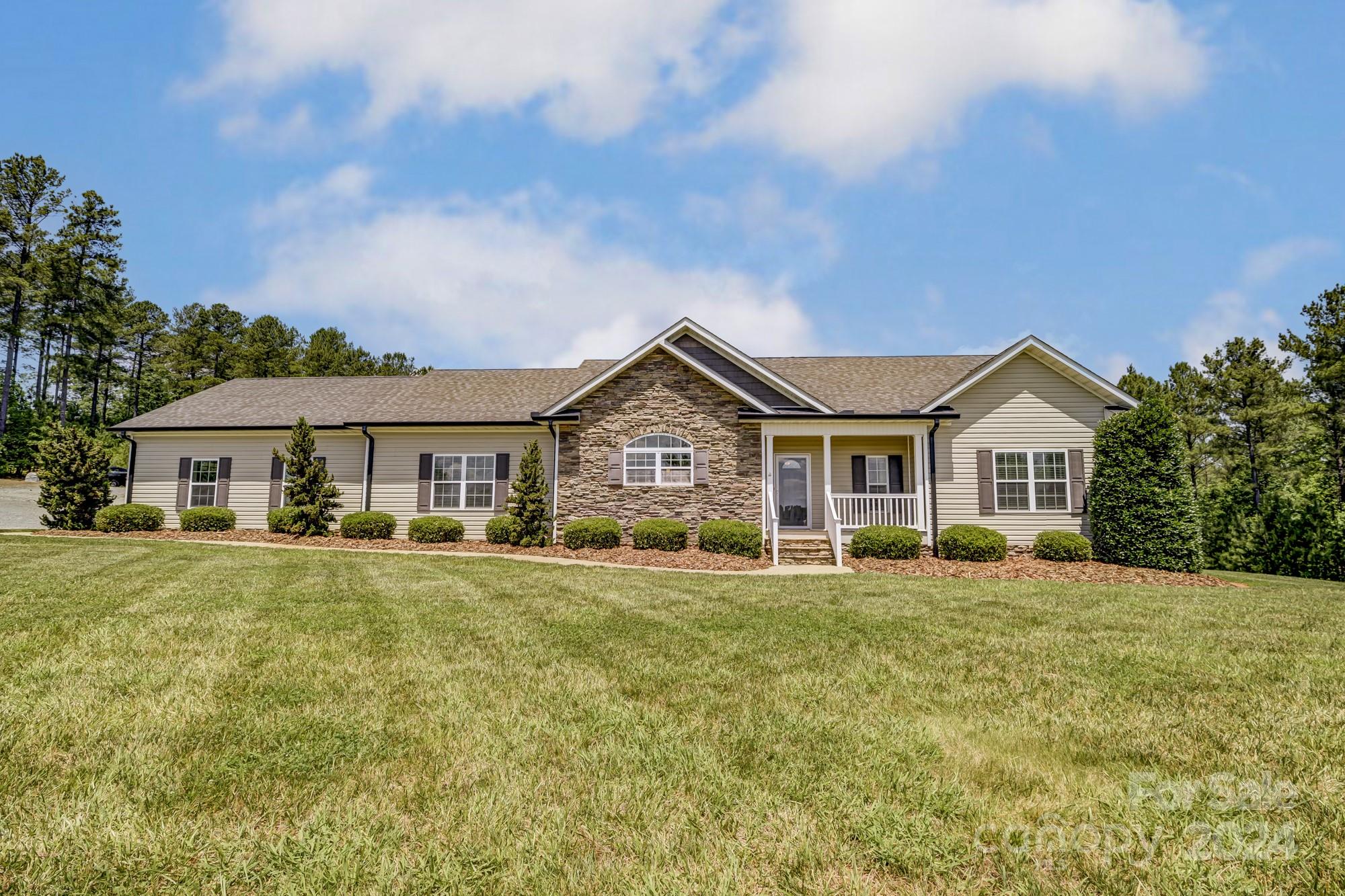 4640 Emanuel Road Gold Hill, NC 28071 - Photo 6 of 48 a big house with a big yard and large trees
