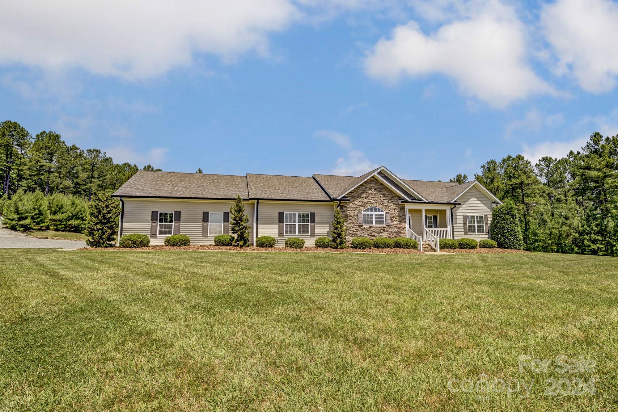 4640 Emanuel Road Gold Hill, NC 28071 - Photo 7 of 48 a front view of a house with a garden