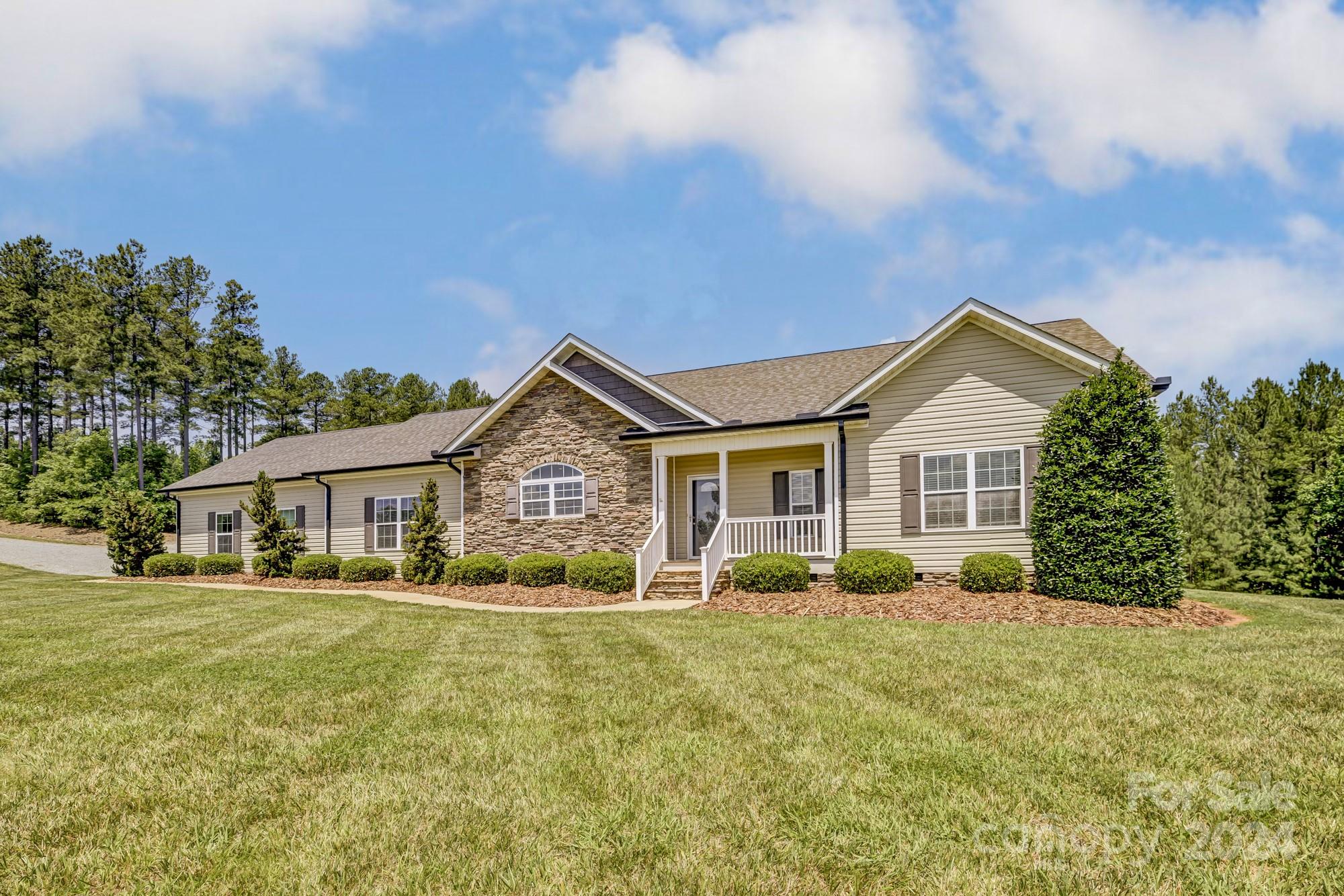 4640 Emanuel Road Gold Hill, NC 28071 - Photo 8 of 48 a front view of a house with a yard