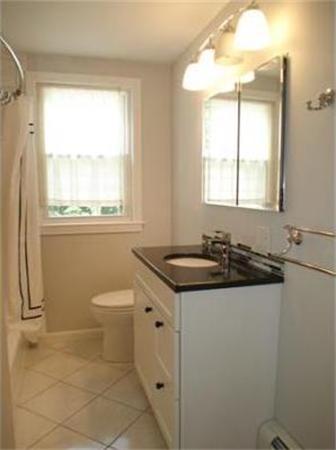 65 Follen Road Lexington, MA 02420 - Photo 15 of 23 a bathroom with a granite countertop sink toilet a mirror and a window