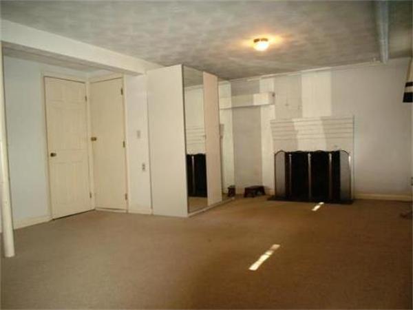 65 Follen Road Lexington, MA 02420 - Photo 17 of 23 a view of an empty room with fireplace and a window