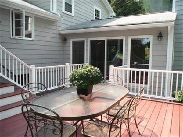65 Follen Road Lexington, MA 02420 - Photo 22 of 23 a view of a patio with table and chairs and potted plants