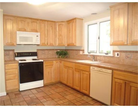 65 Follen Road Lexington, MA 02420 - Photo 5 of 23 a kitchen with stainless steel appliances granite countertop a stove a sink and a microwave
