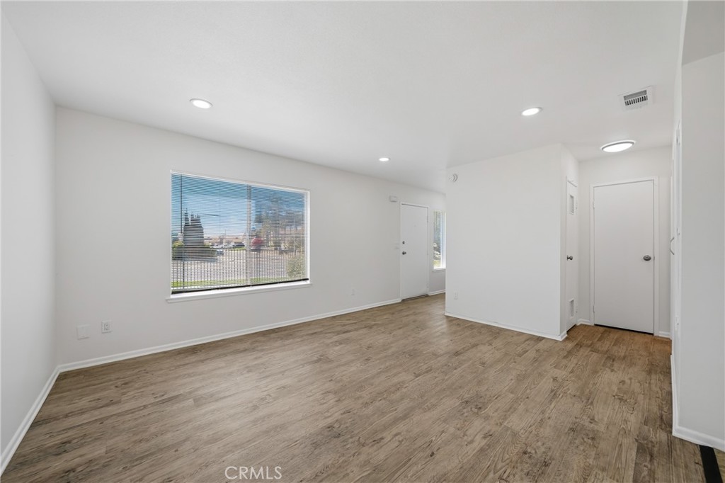 3469 Columbia Avenue Riverside, CA 92501 - Photo 11 of 31 a view of an empty room with wooden floor and window