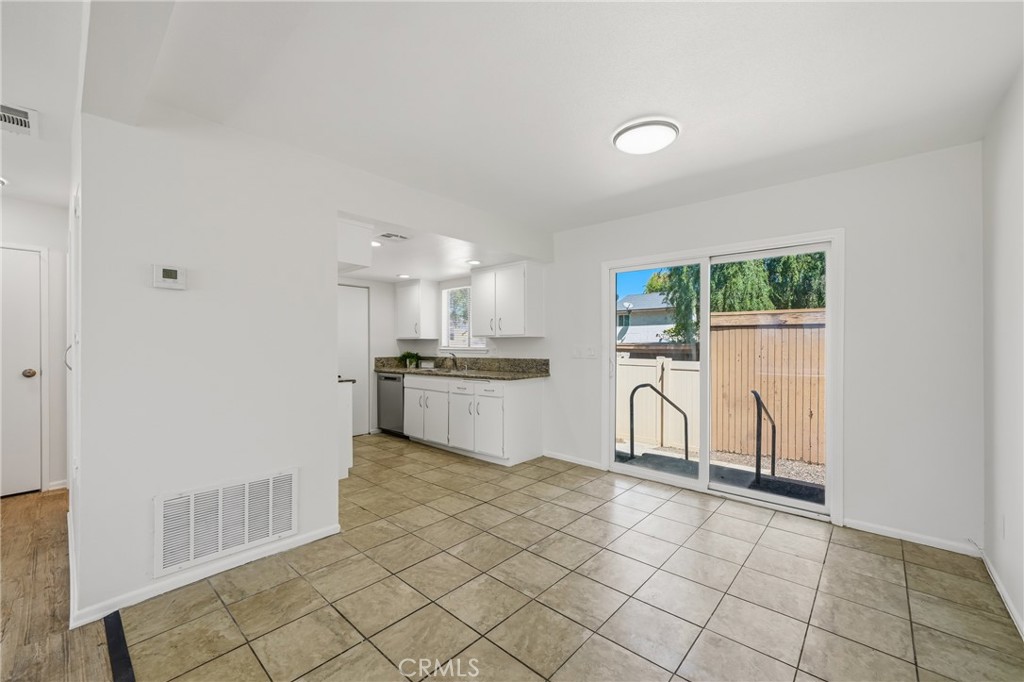 3469 Columbia Avenue Riverside, CA 92501 - Photo 12 of 31 a kitchen with white cabinets and appliances