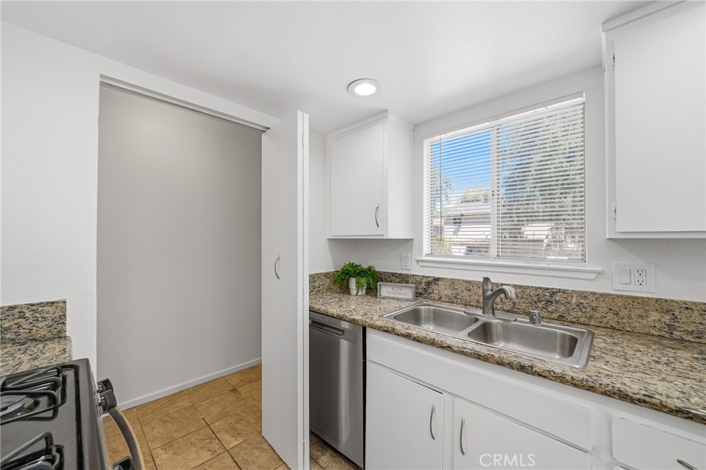 3469 Columbia Avenue Riverside, CA 92501 - Photo 12 of 30 a bathroom with a granite countertop sink and a mirror