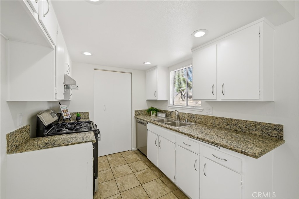 3469 Columbia Avenue Riverside, CA 92501 - Photo 8 of 30 a kitchen with stainless steel appliances granite countertop a sink stove and cabinets