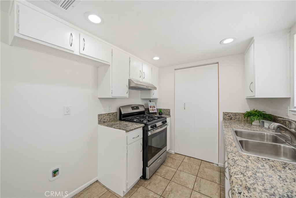 3469 Columbia Avenue Riverside, CA 92501 - Photo 9 of 30 a kitchen with stainless steel appliances granite countertop a sink stove and cabinets