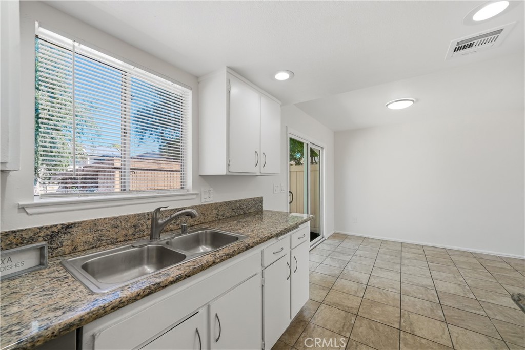 3469 Columbia Avenue Riverside, CA 92501 - Photo 9 of 31 a kitchen with a sink cabinets and window