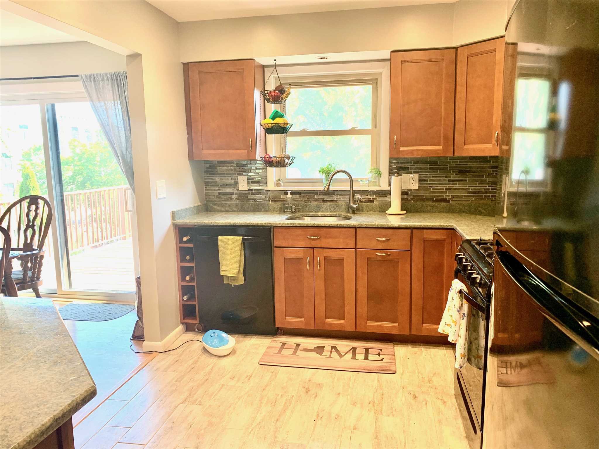 6 Academy Street Beacon, NY 12508 - Photo 3 of 22 a bathroom with a granite countertop sink and a large mirror
