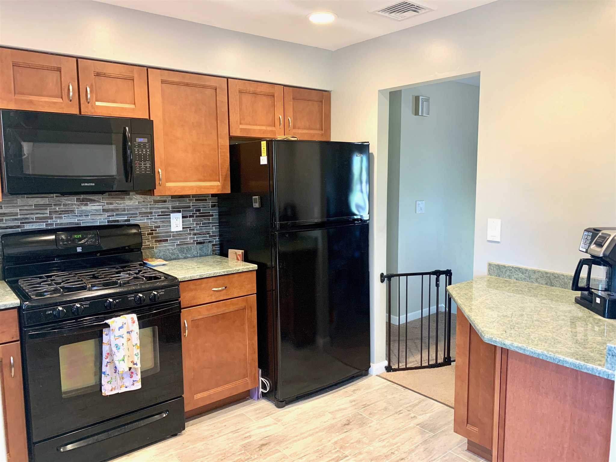 6 Academy Street Beacon, NY 12508 - Photo 5 of 22 a kitchen with granite countertop a refrigerator stove and oven