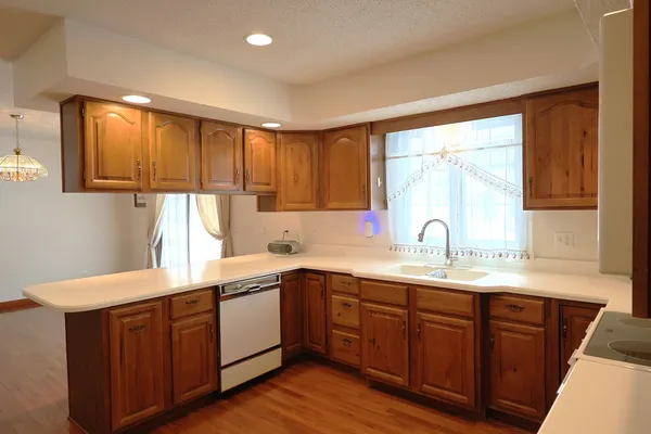 a kitchen with a sink a window and cabinets