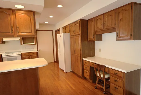 a kitchen with stainless steel appliances a refrigerator and a stove