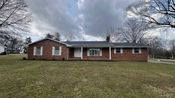 a front view of a house with yard