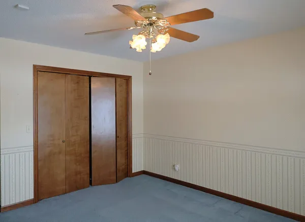 a view of a room with a table and chairs