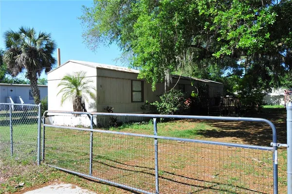 a view of a backyard with plants and a patio