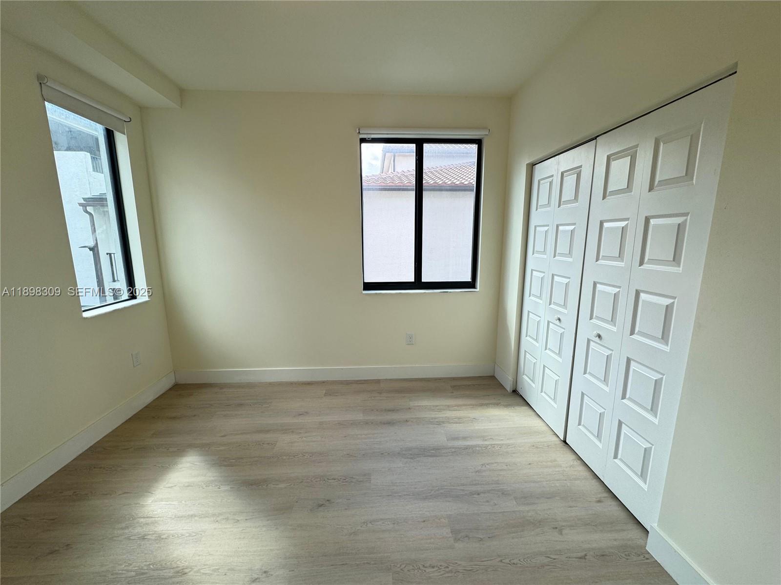 4802 Northwest 83rd Path Doral, FL 33166 - Photo 11 of 25 an empty room with windows