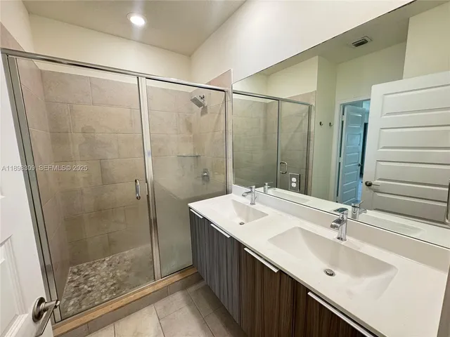 a bathroom with a double vanity sink and a mirror