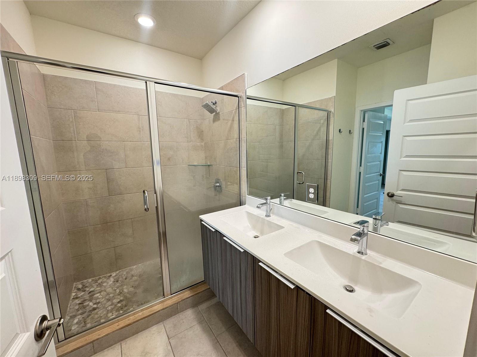 4802 Northwest 83rd Path Doral, FL 33166 - Photo 16 of 25 a bathroom with a double vanity sink and a mirror