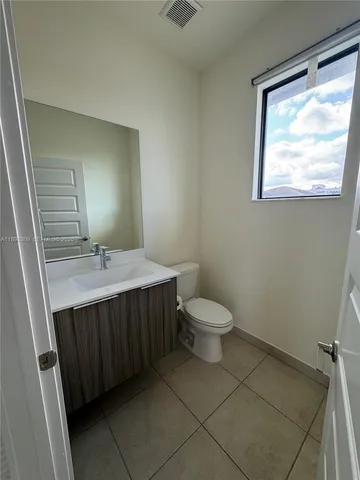 a bathroom with a sink vanity and a toilet