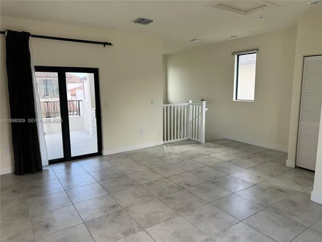 a view of a hallway with entryway door