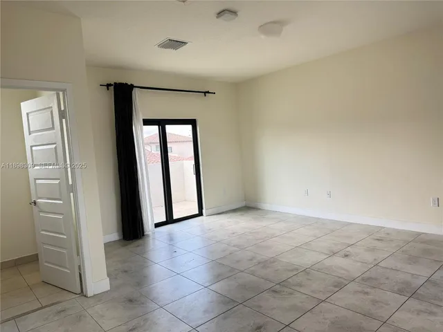a kitchen with a fireplace and cabinets