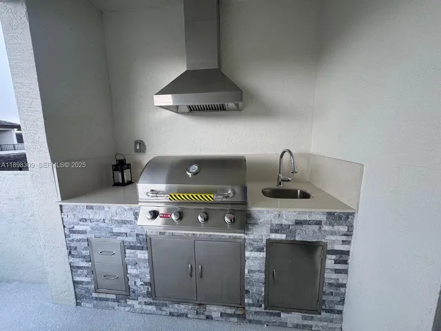 a kitchen with stove and cabinets