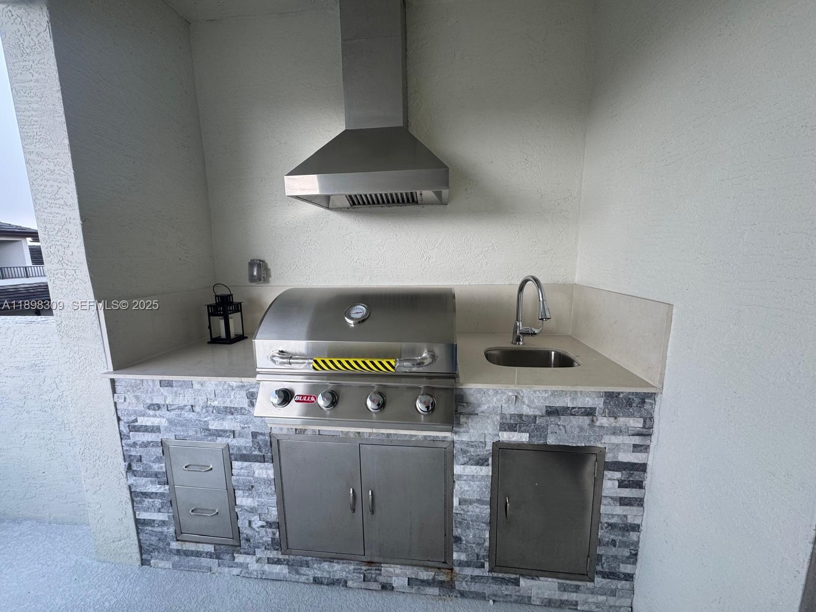 4802 Northwest 83rd Path Doral, FL 33166 - Photo 23 of 25 a kitchen with a fireplace and cabinets