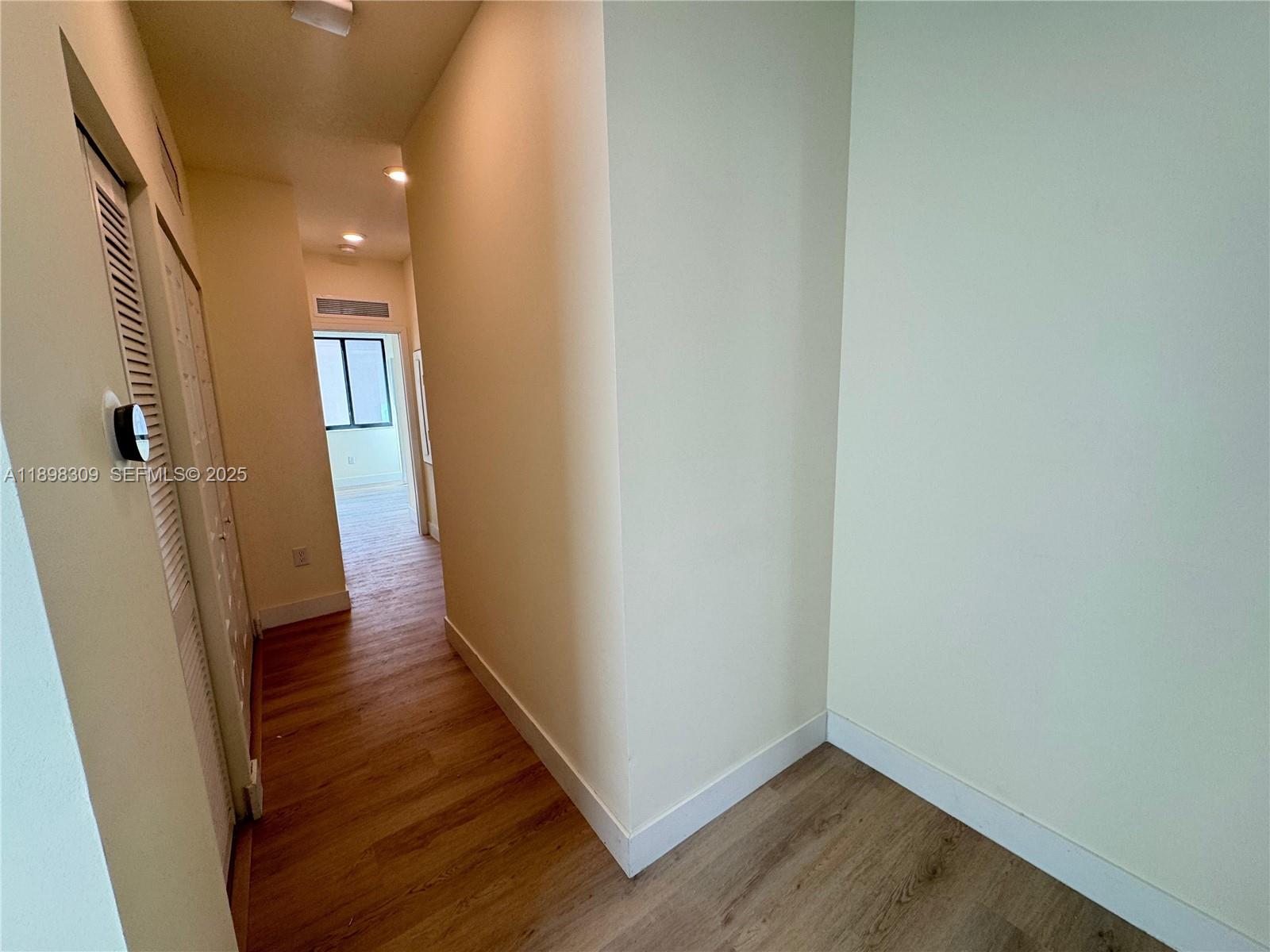 4802 Northwest 83rd Path Doral, FL 33166 - Photo 9 of 25 a view of a hallway with wooden floor