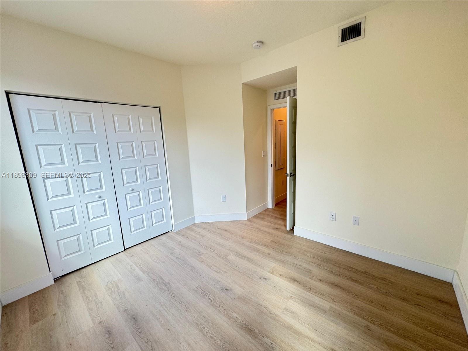 4802 Northwest 83rd Path Doral, FL 33166 - Photo 10 of 25 a view of front door with wooden floor