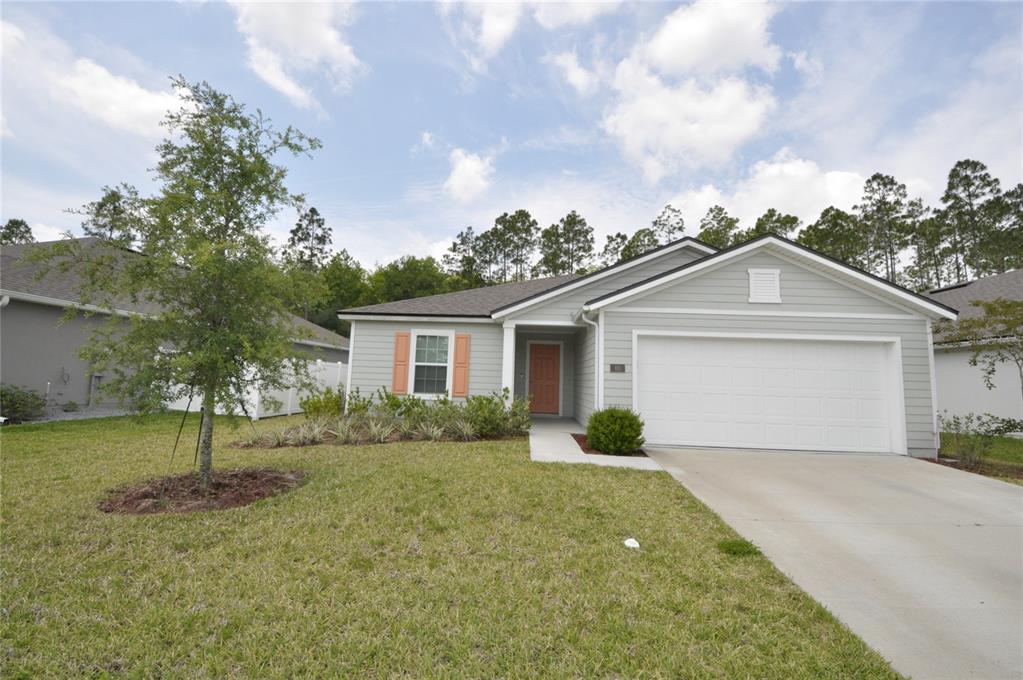 80 Oakleaf Way Palm Coast, FL 32137 - Photo 1 of 33 a view of a house next to a yard with big trees