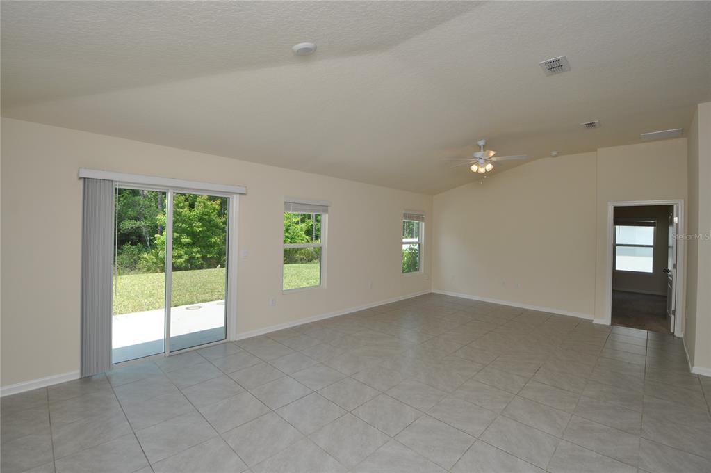 80 Oakleaf Way Palm Coast, FL 32137 - Photo 11 of 33 an empty room with windows