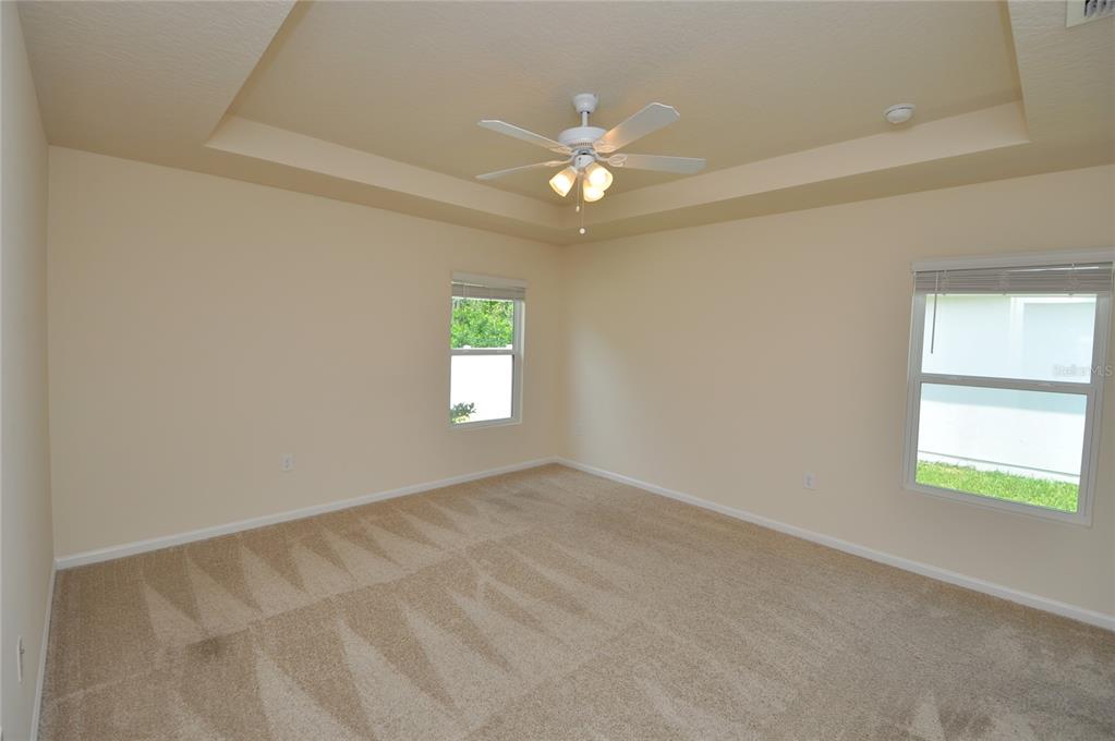 80 Oakleaf Way Palm Coast, FL 32137 - Photo 16 of 33 an empty room with windows and chandelier fan