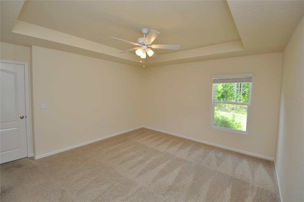 80 Oakleaf Way Palm Coast, FL 32137 - Photo 17 of 33 an empty room with a window and a fan