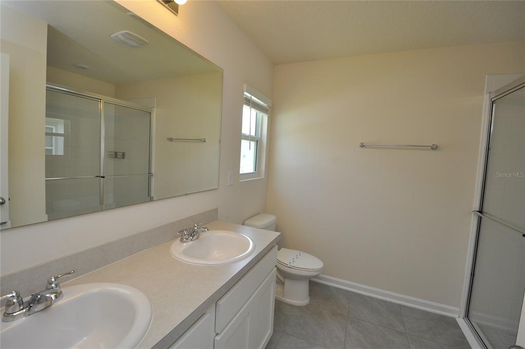 80 Oakleaf Way Palm Coast, FL 32137 - Photo 20 of 33 a bathroom with a granite countertop sink toilet and mirror
