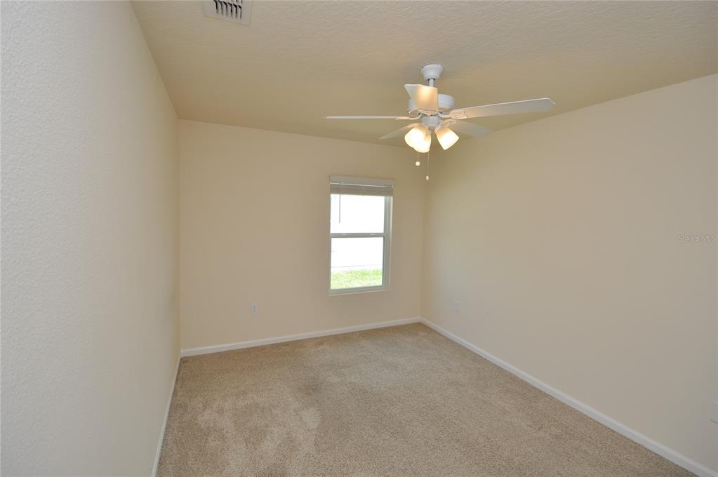 80 Oakleaf Way Palm Coast, FL 32137 - Photo 24 of 33 an empty room with a window and a fan