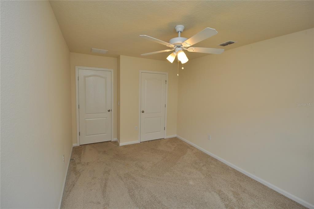 80 Oakleaf Way Palm Coast, FL 32137 - Photo 25 of 33 an empty room with a window and ceiling fan