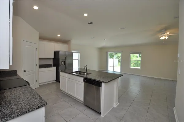a kitchen with stainless steel appliances granite countertop a sink and a stove