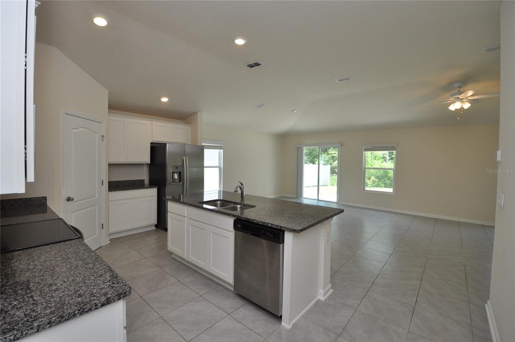 80 Oakleaf Way Palm Coast, FL 32137 - Photo 4 of 33 a kitchen with stainless steel appliances granite countertop a sink and a stove