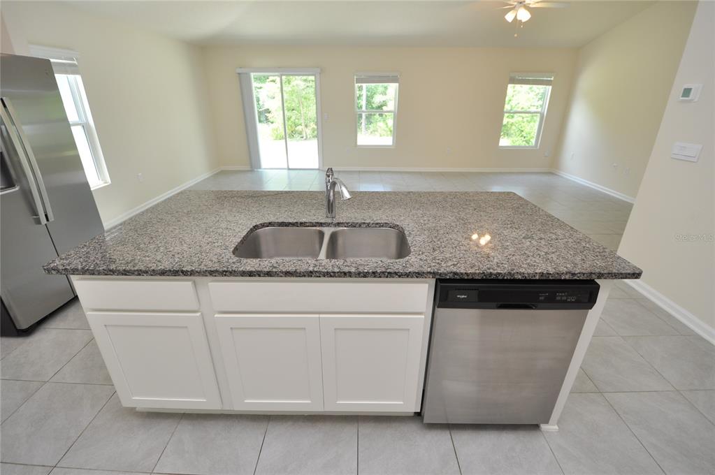 80 Oakleaf Way Palm Coast, FL 32137 - Photo 9 of 33 a kitchen with granite countertop white cabinets and a sink