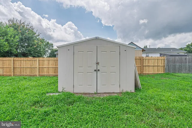 a view of a backyard with wooden fence